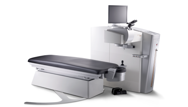 Sistema laser wavelight EX500 con lettino regolabile, microscopio e monitor, utilizzato per la chirurgia refrattiva corneale.