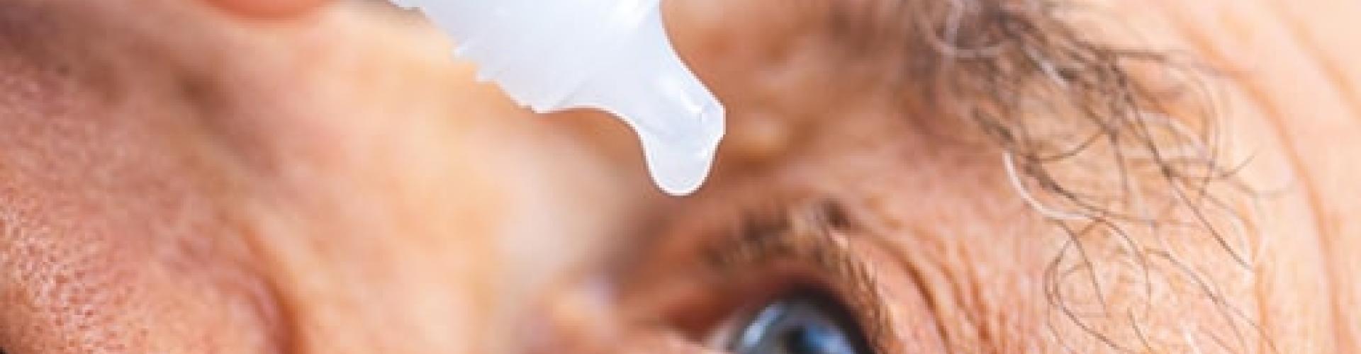 Elderly person during eye drops