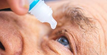 Elderly person during eye drops