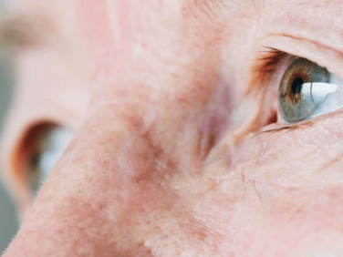 close-up on green eye of an elderly man