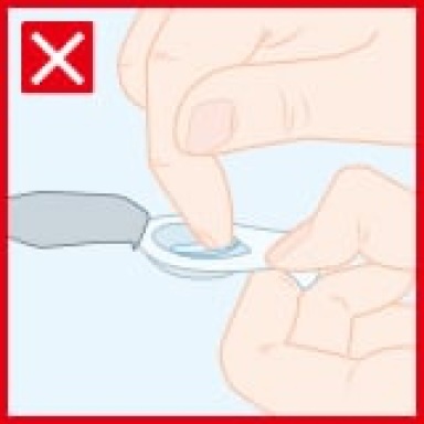 Demonstration of how using nails can harm a contact lens