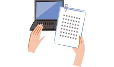 Hand using a laptop next to a notebook