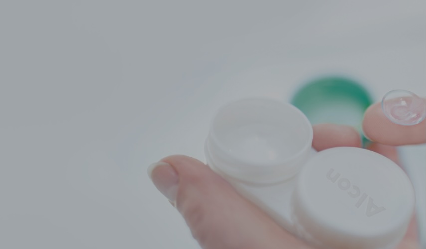 Image of lens on finger and packaging for contact lenses