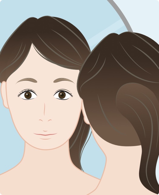 Woman looking at herself in a mirror