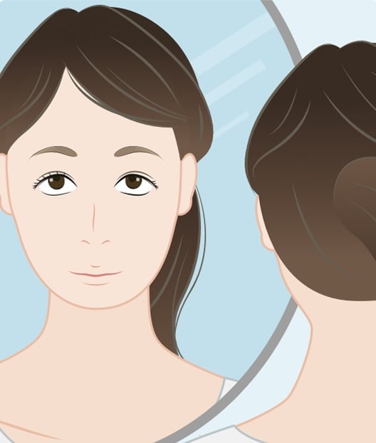 Woman looking at herself in a mirror