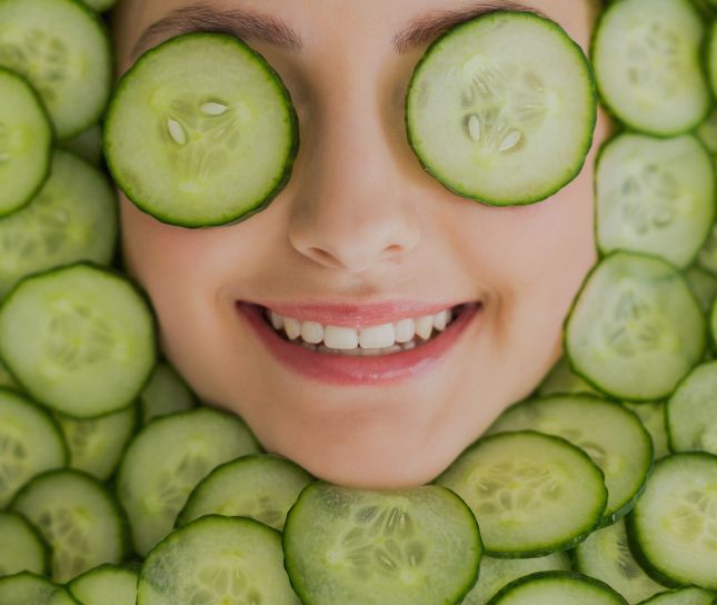 Woman with cucumber slices