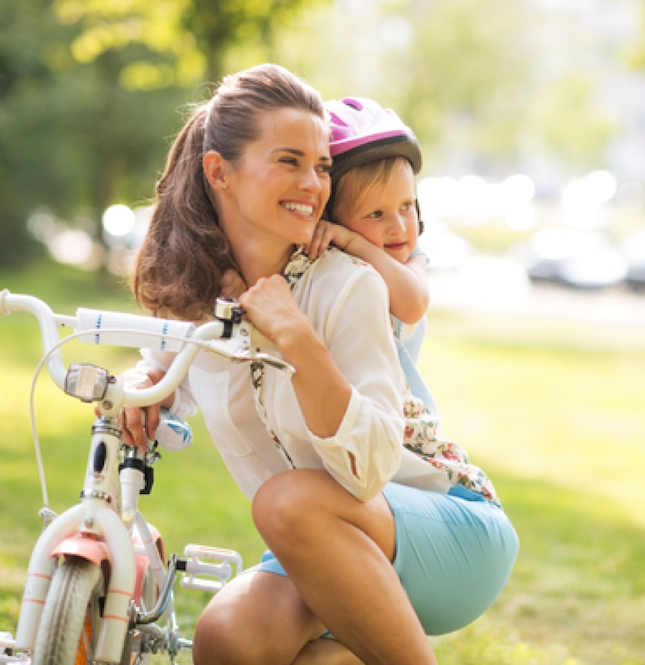 woman with bicycle and baby on her back