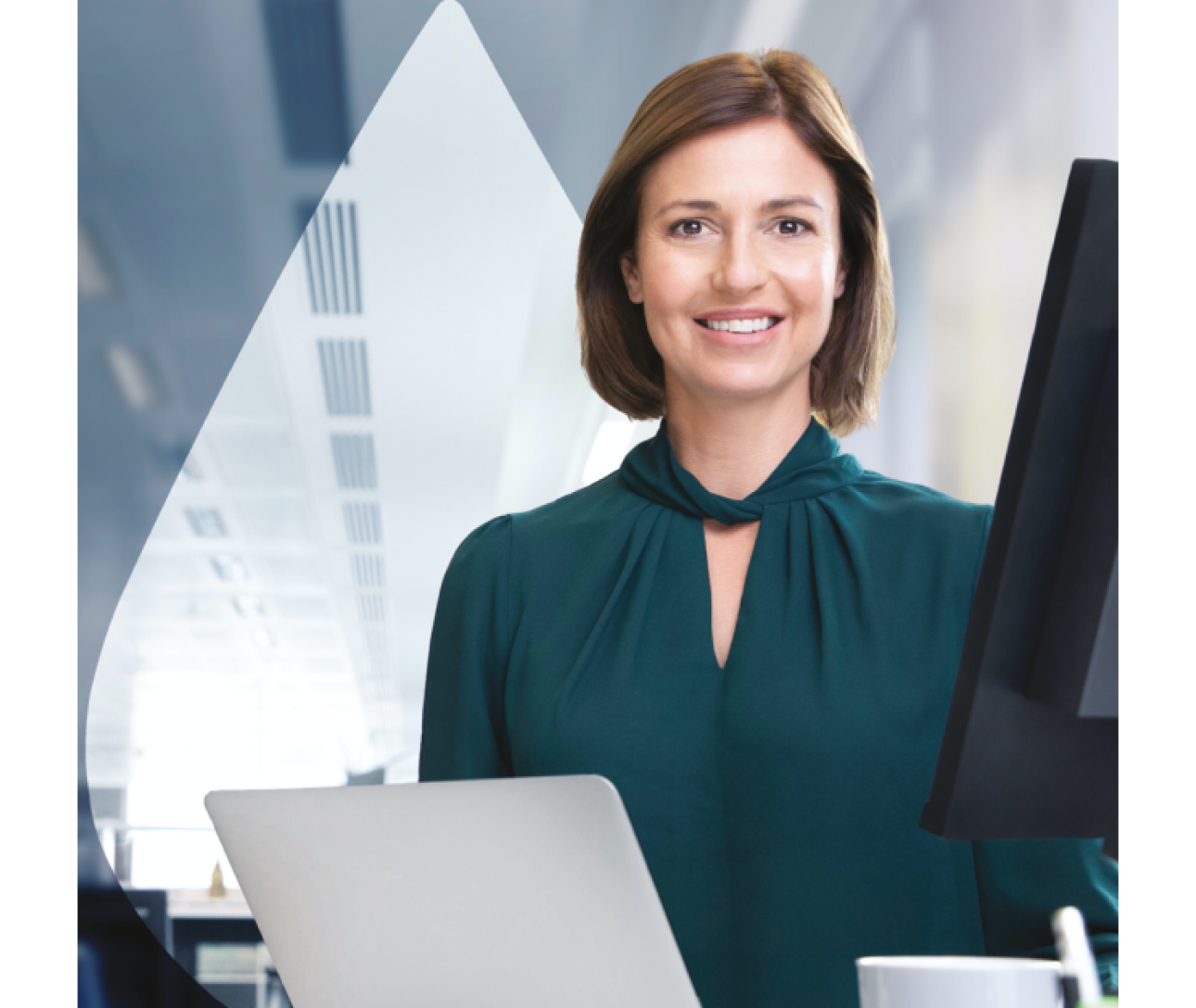smiling woman standing in front of monitors