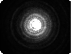 Black background with a bright light in the middle, with a halo around the light larger than the Clareon Monofocal and Clareon Vivity IOLs, representing the optical bench halo measurement for Zeiss AT LARA Diffractive IOL.