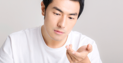 Man with contact lens on his finger