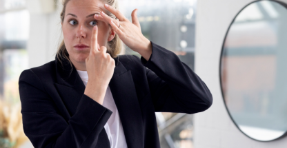 Woman putting on a contact lens