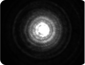 Black background with a bright light in the middle, with a halo around the light larger than the Clareon Monofocal and Clareon Vivity IOLs, representing the optical bench halo measurement for Zeiss AT LARA Diffractive IOL.