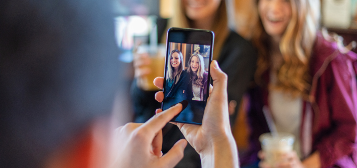 Woman taking photo of friends