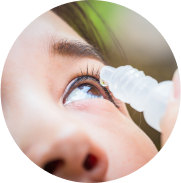 Closeup applying dry eye drops in eye