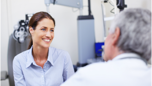 Woman smiling while speaking with her eye doctor.