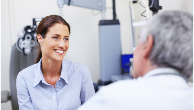 Woman sitting with her eye doctor.