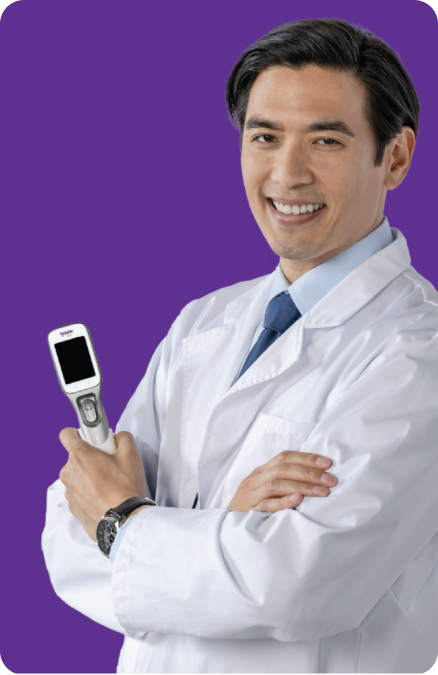 Smiling eye doctor holding Systane® iLux ²® device