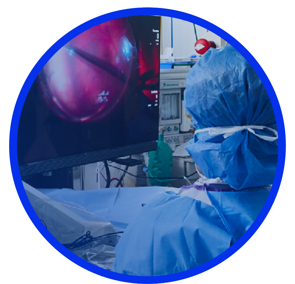 An image of a group of surgeons in an operating room with a patient undergoing surgery. An NGENUITY screen shows a close-up view of the surgery to the surgeons in the room.