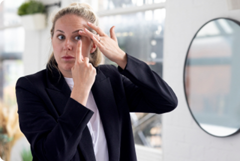 Woman putting in a contact lens