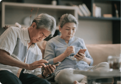 Elderly couple looking for information on their phone