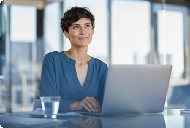 Smiling woman with a laptop in the office