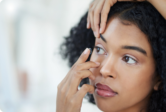 Woman applying a contact lens