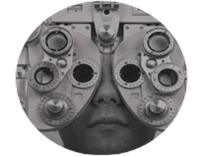 Close-up of a person's face during an eye examination, in muted grey tones