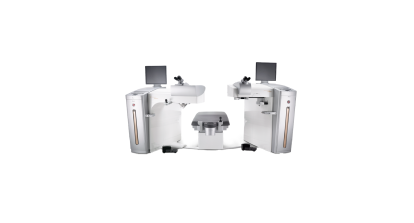 Alcon LASIK surgical suite featuring two laser systems positioned on either side of a central patient bed, with monitors and microscopes for precision eye surgery.