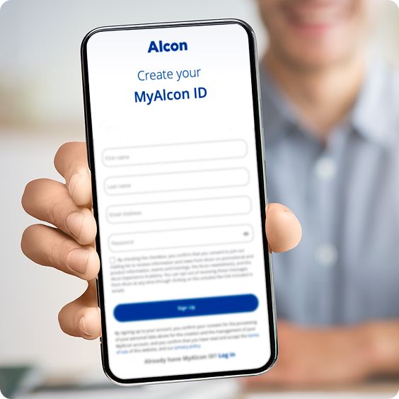 Person holding a smartphone displaying the Alcon MyAlcon ID registration screen, with visible form fields for creating an account.