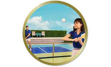 Woman playing tennis on an outdoor court while a man stands on the opposite side of the net