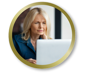 Woman looking at her computer screen with a focused expression