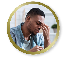 Man rubbing his eyes, representing discomfort or eye strain from vision challenges