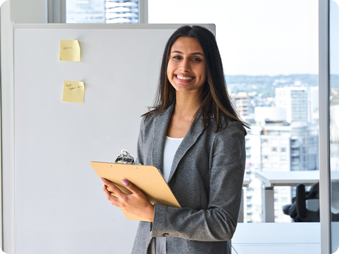 A smiling woman at the blackboard
