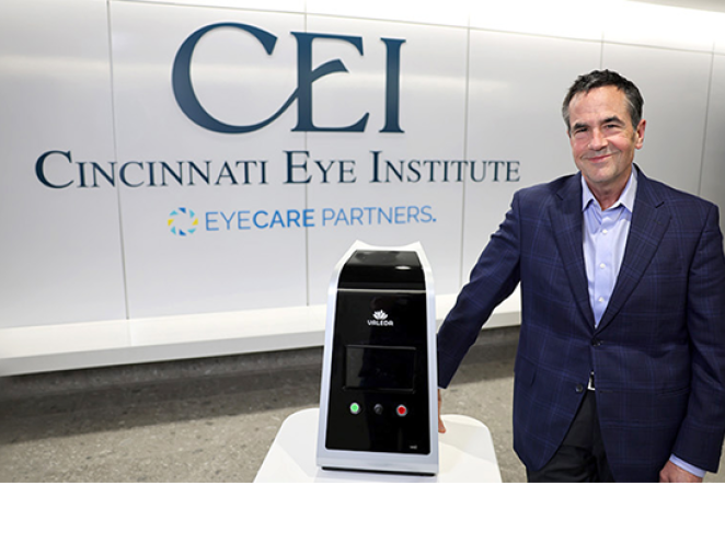 Rob Foster, M.D., of Cincinnati Eye Institute (CEI), standing beside the Valeda™ Light Delivery System in the CEI clinic