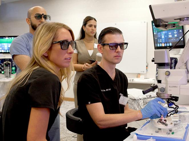 Eye care professionals wearing protective glasses during hands-on ophthalmic technology training at the Alcon Experience Center