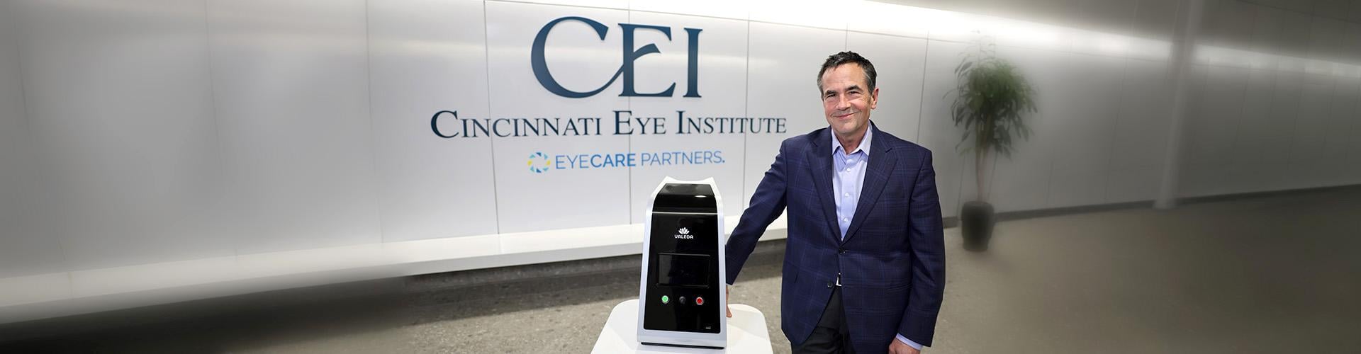 Rob Foster, M.D., of Cincinnati Eye Institute (CEI), standing beside the Valeda™ Light Delivery System in the CEI clinic