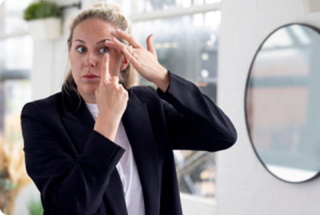 Woman putting in a contact lens