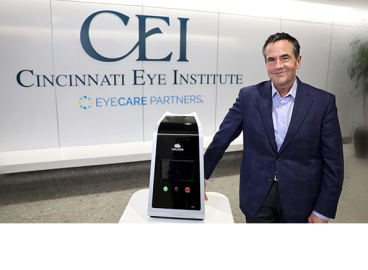 Rob Foster, M.D., of Cincinnati Eye Institute (CEI), standing beside the Valeda™ Light Delivery System in the CEI clinic
