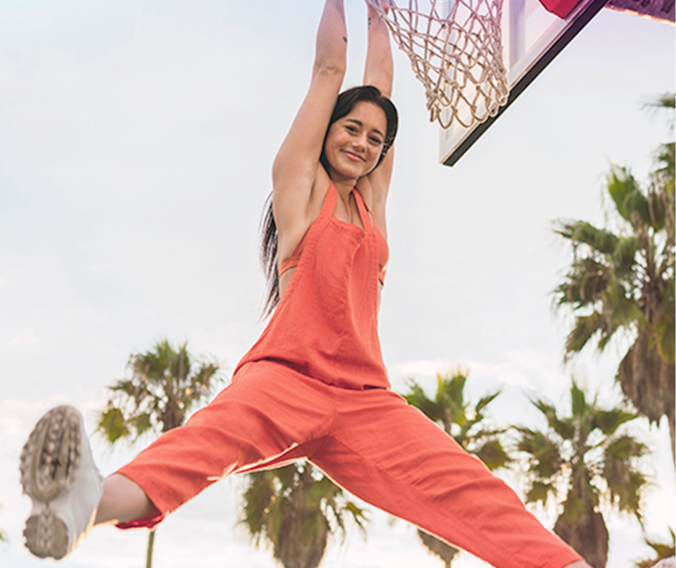 Girl playing basketball in overalls