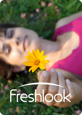 Woman wearing pink holding out yellow flower