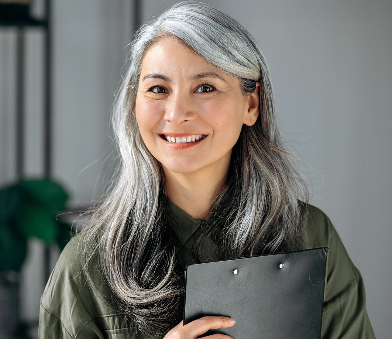 Smiling elderly woman with a notebook