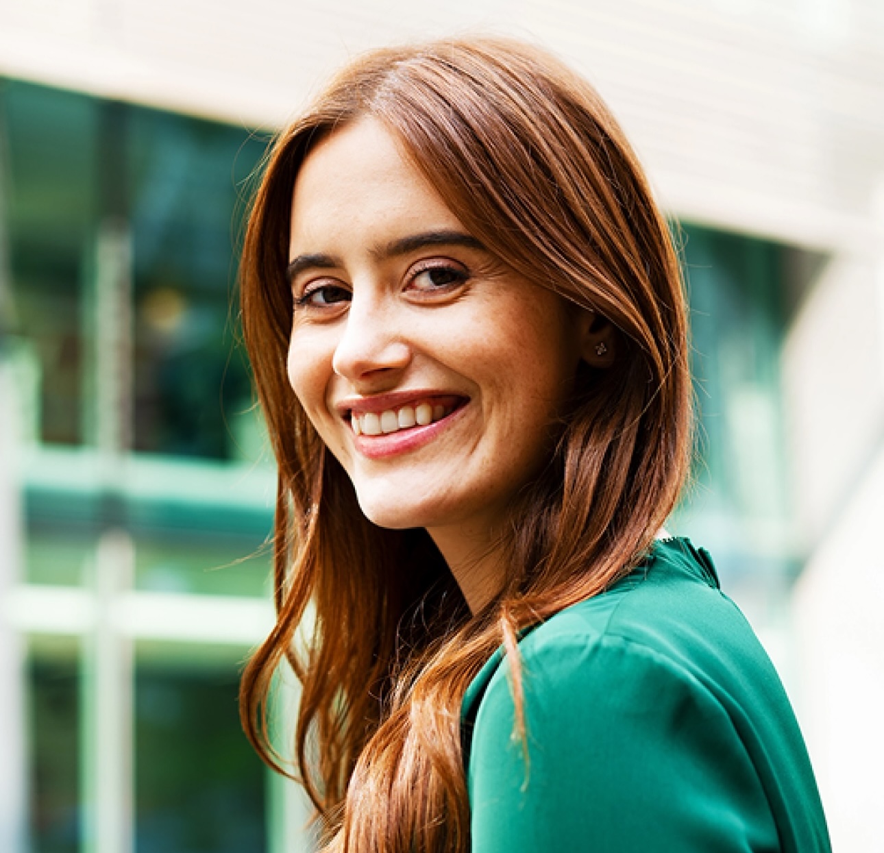 Young smiling brunette in a green blouse