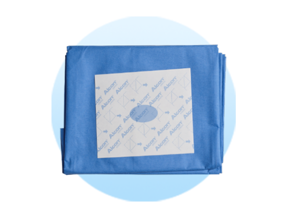 Folded surgical drapes on a pale blue circle background.