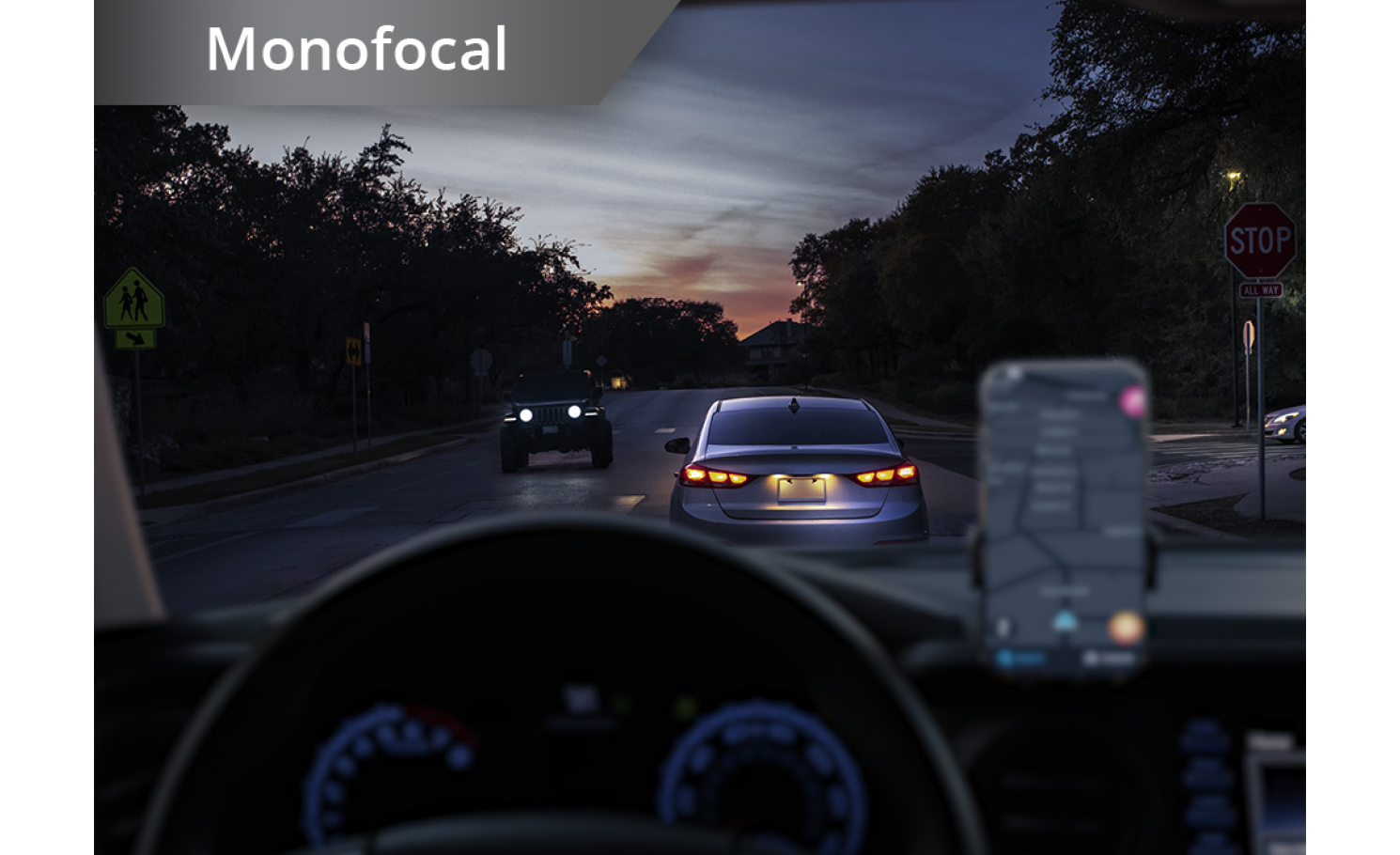 Car on the road in dim lighting with phone set up on the dashboard. White text at the top left corner of this image reads “Monofocal.”