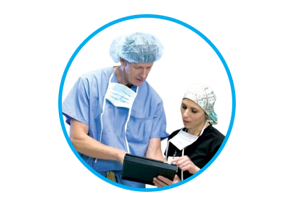 An image of man and woman wearing a black and blue scrubs. They are both looking at something on a tablet.