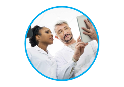 An image of man and woman wearing lab coats. The man is showing the woman something on a tablet.