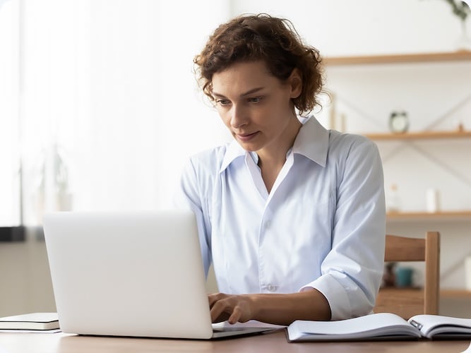 Woman at a desk with a laptop