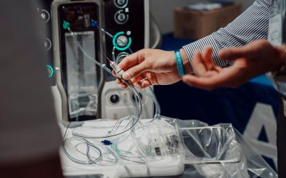 Close-up of surgical tubing and disposable components connected to an Alcon ophthalmic surgical system during a product demonstration.