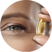 Closeup of eye and woman holding eye vitamin