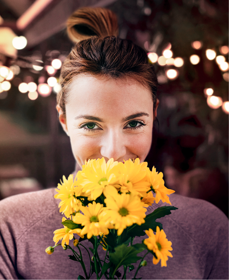 Woman with flowers smiling